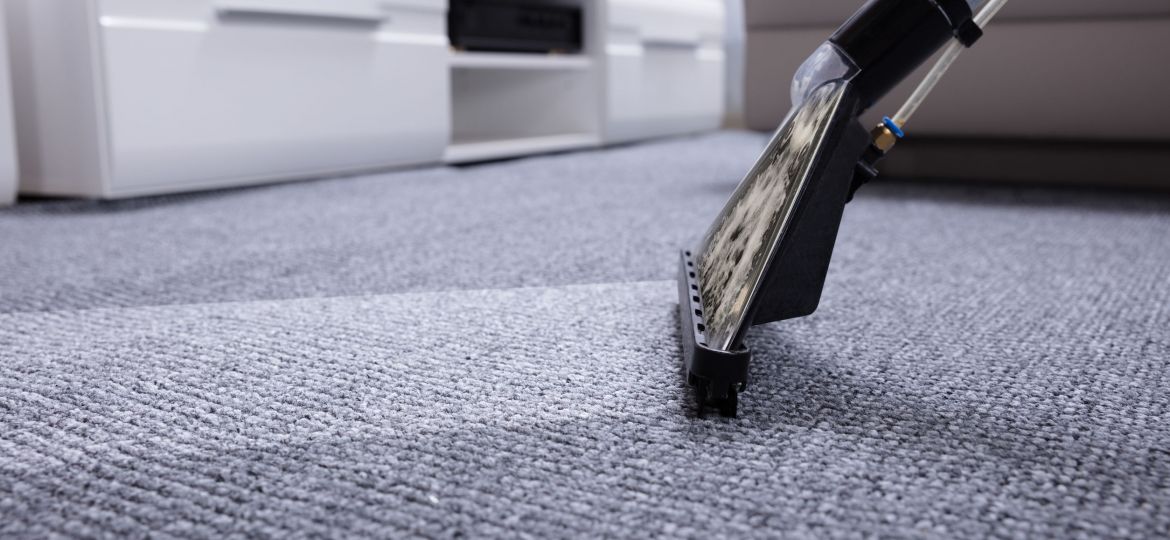 Close-up Of A Vacuum Cleaner Over Grey Carpet